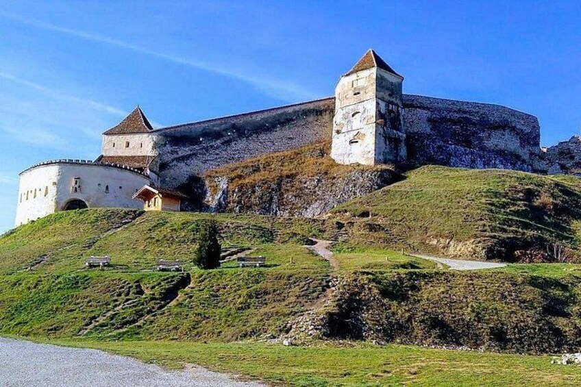 A historic castle on a hill with a clear sky. 2