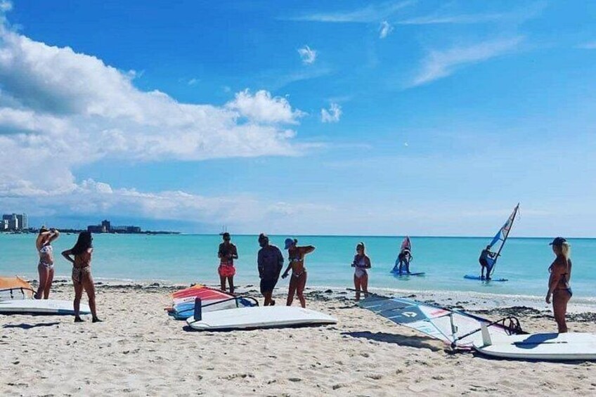 Une plage avec des gens, des planches de surf et un ciel dégagé. 1