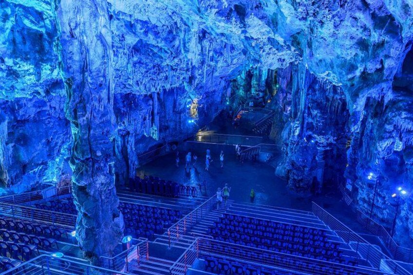 An ice cave with a viewing platform and seating area. 1