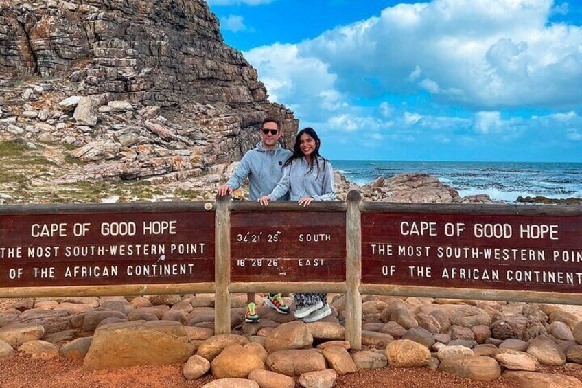 A couple standing in front of a sign at Cape of Good Hope, the most southwestern point of the African continent. 2