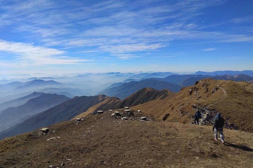 A mountainous landscape with hikers and a clear sky. 4