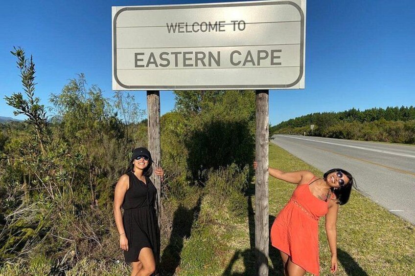 A welcome sign for Eastern Cape with two people posing beside it. 1