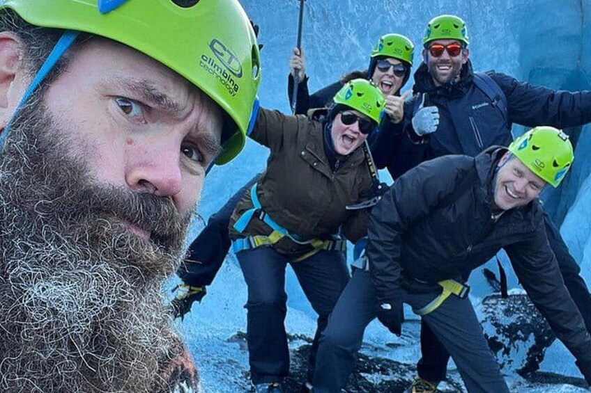 A group of people wearing helmets and harnesses, engaged in a climbing activity. 2