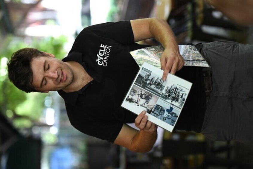 A person holding a booklet with photographs. 3