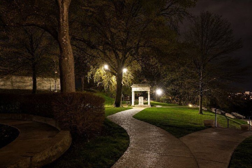 A nighttime park scene with a pathway leading to a gazebo. 5