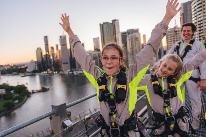 People bungee jumping with a city skyline in the background. 1