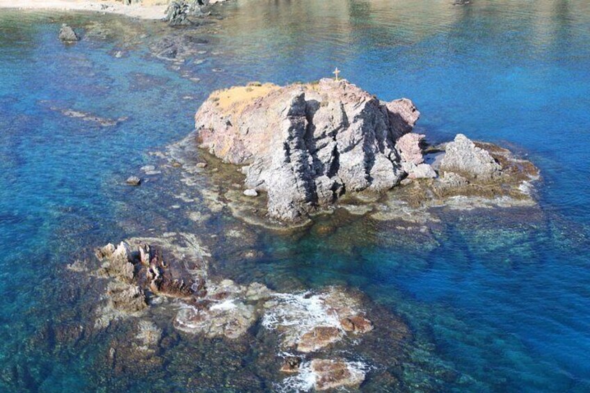Una isla rocosa rodeada de aguas azules cristalinas. 2