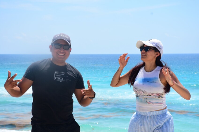 Twee mensen dansen op het strand, met de oceaan op de achtergrond. 3