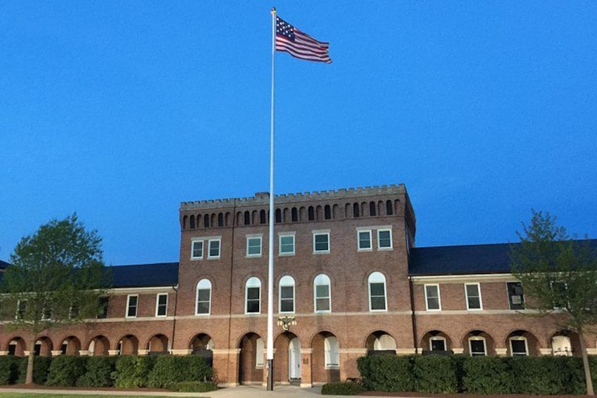 A brick building with a flagpole and an American flag. 2