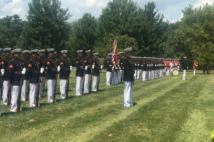 A military parade with soldiers in uniform standing in formation. 4