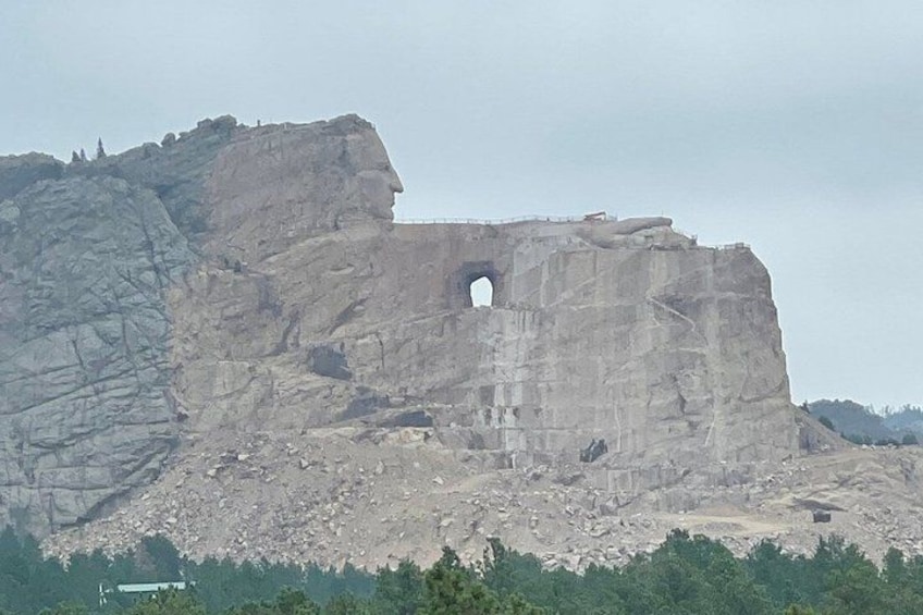 A large rock formation with a prominent cave-like opening. 4