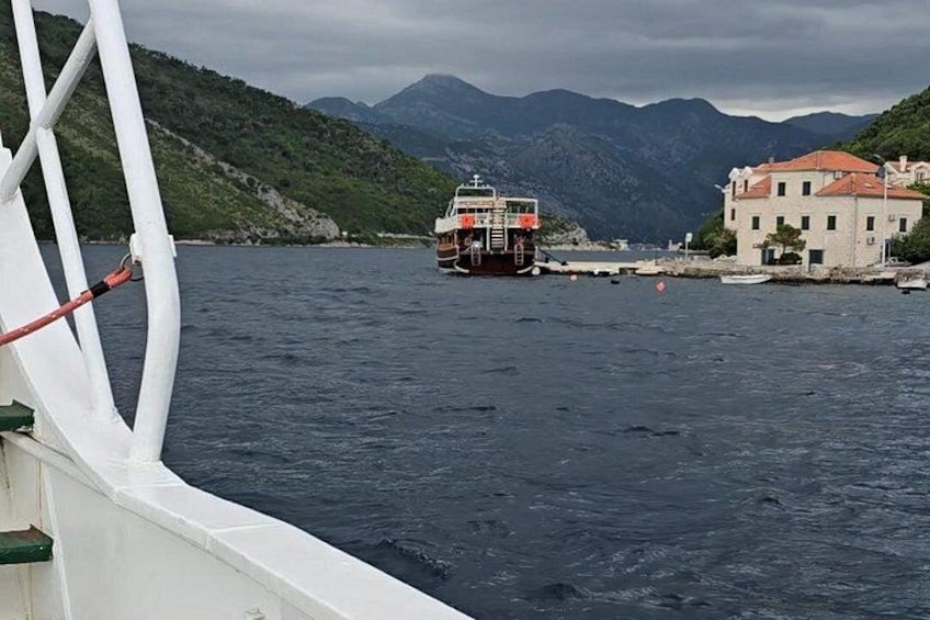 A boat on a body of water with mountains in the background. 5