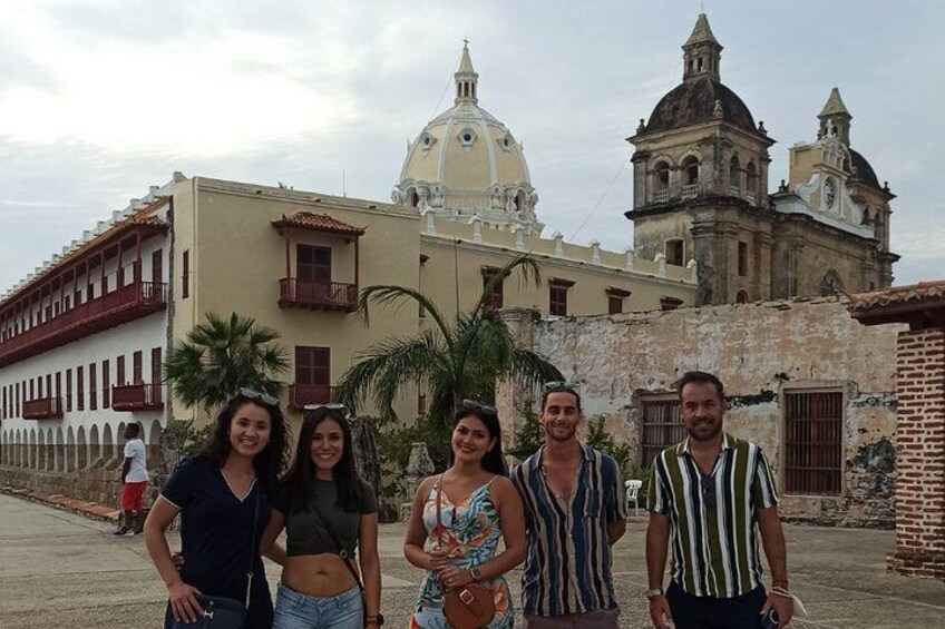 A group of people standing in front of historical buildings with domes and arches. 1