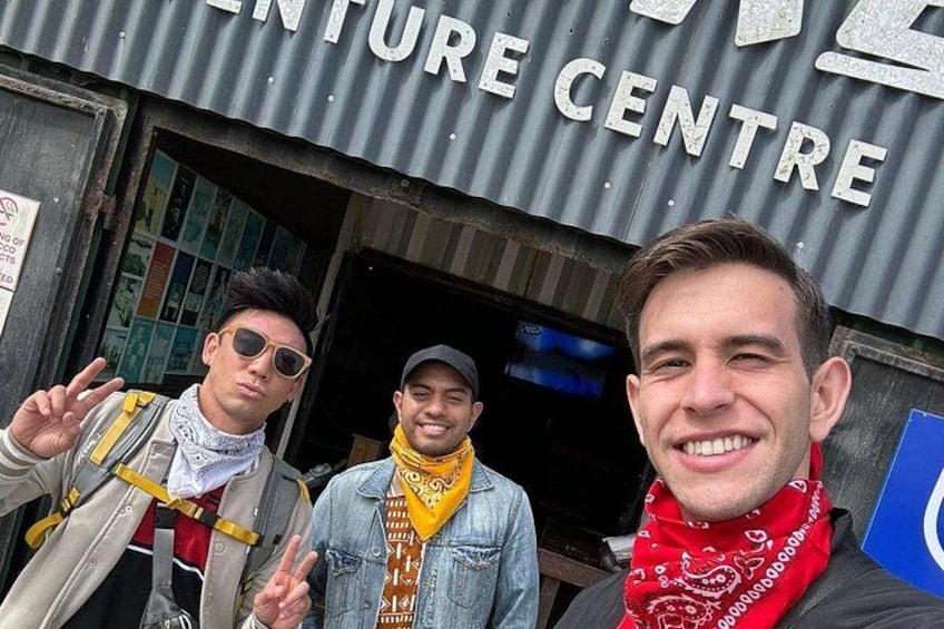 Three people in front of a building with a sign that reads 'ENTURE CENTRE'. 3