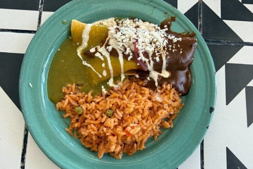 A plate with a green sauce, rice, and a tamale. 4