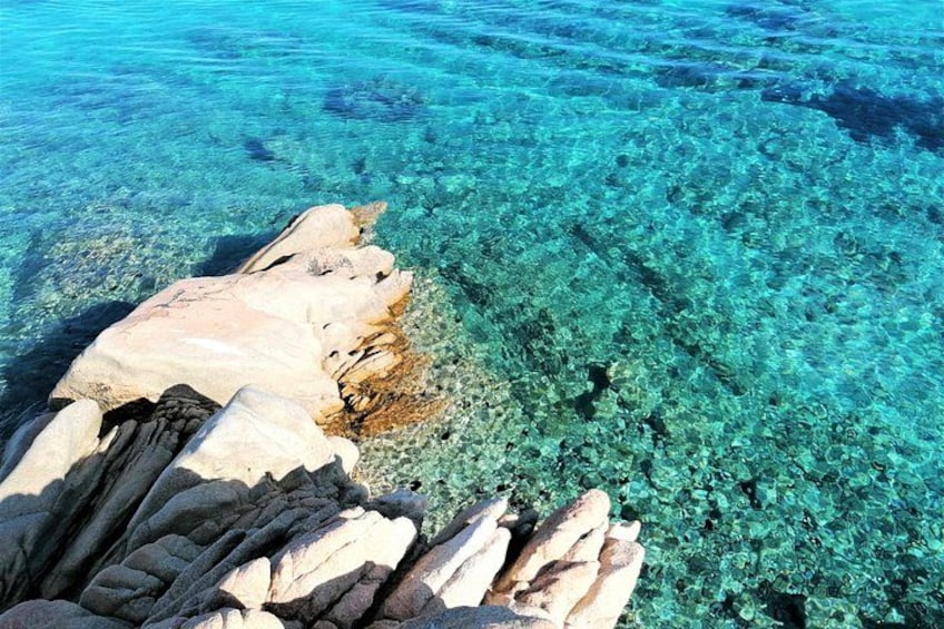 A rocky shoreline with clear turquoise water. 3
