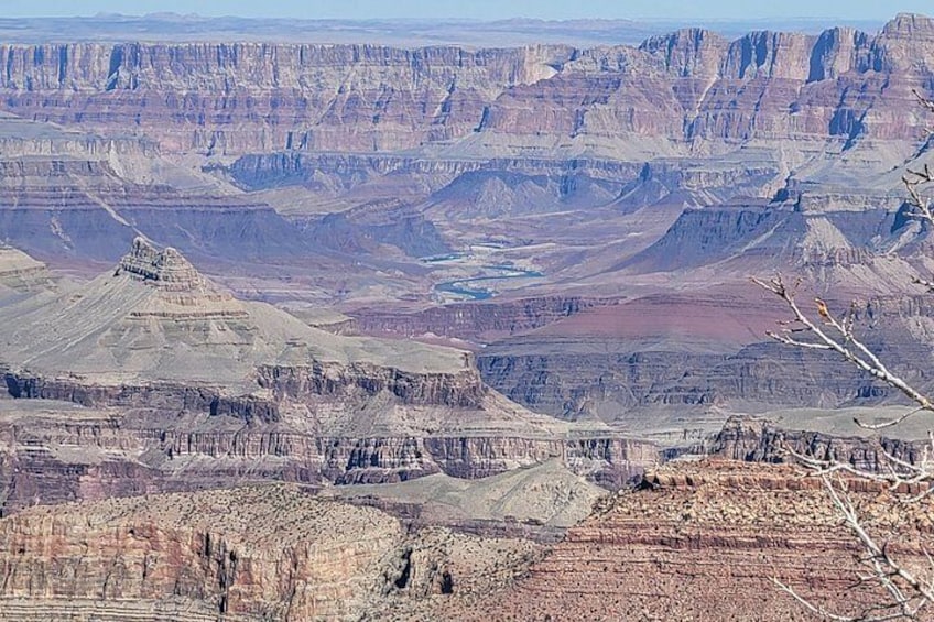 A vast canyon landscape with layered rock formations and a river. 3