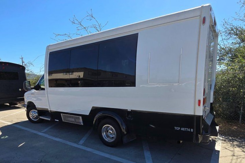 A white van parked in a lot with a visible license plate number TCP 46774 B. 5
