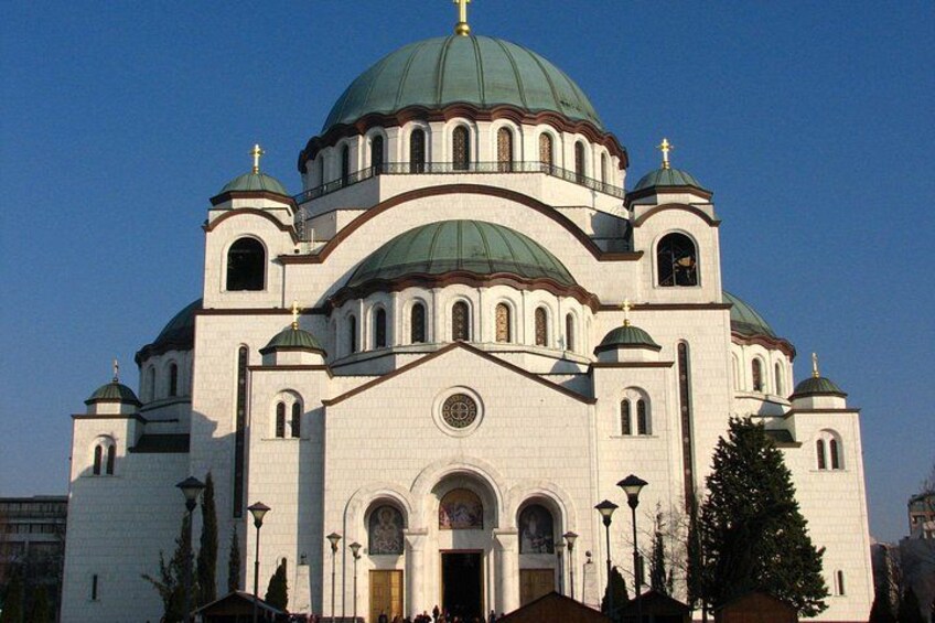 A large white church with multiple domes and arched windows. 1