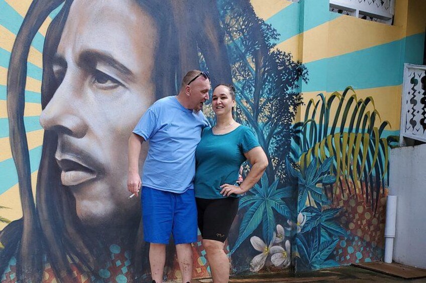 A mural with a woman's portrait and tropical plants. 4