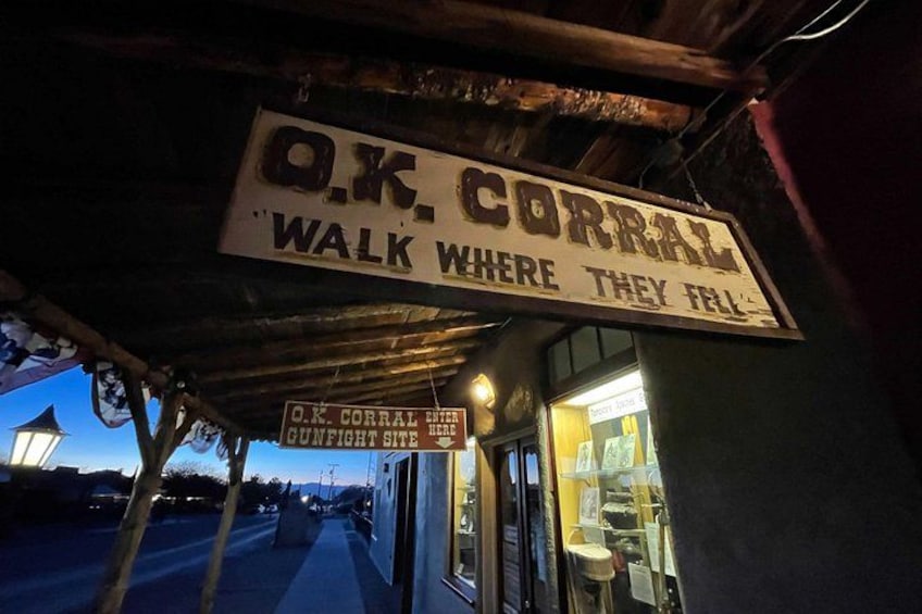 A street sign for O.K. Corrall with a slogan 'Walk where they fall'. 1