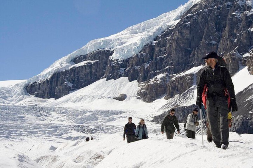 Hiking down the glacier with the impressive icefalls in the background 2