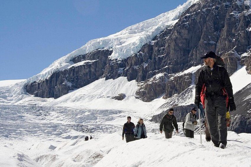 Hiking down the glacier with the impressive icefalls in the background 2