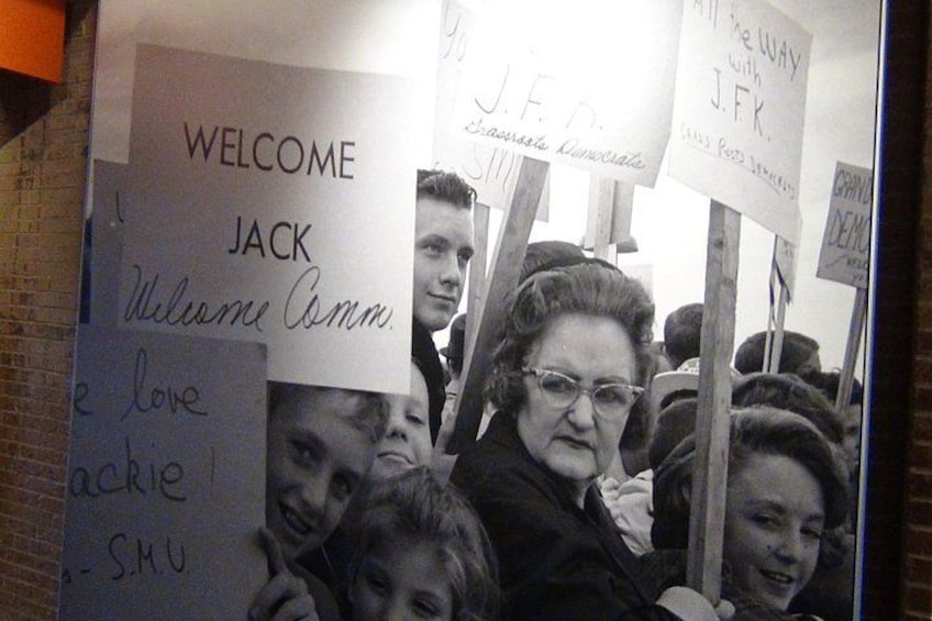 A crowd of people holding signs with names and messages. 2