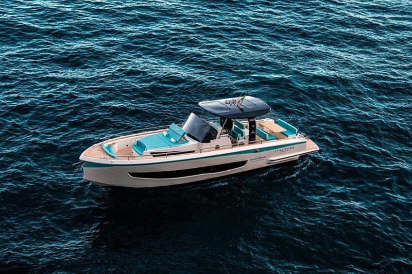 A white motorboat with a canopy on the water. 3