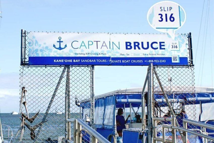 A boat with a sign advertising 'Captain Bruce' and 'Kane Ohe Bay Sandbar Tours.' 4