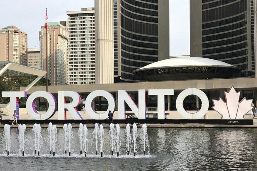 The Toronto CN Tower with a water fountain in front. 2