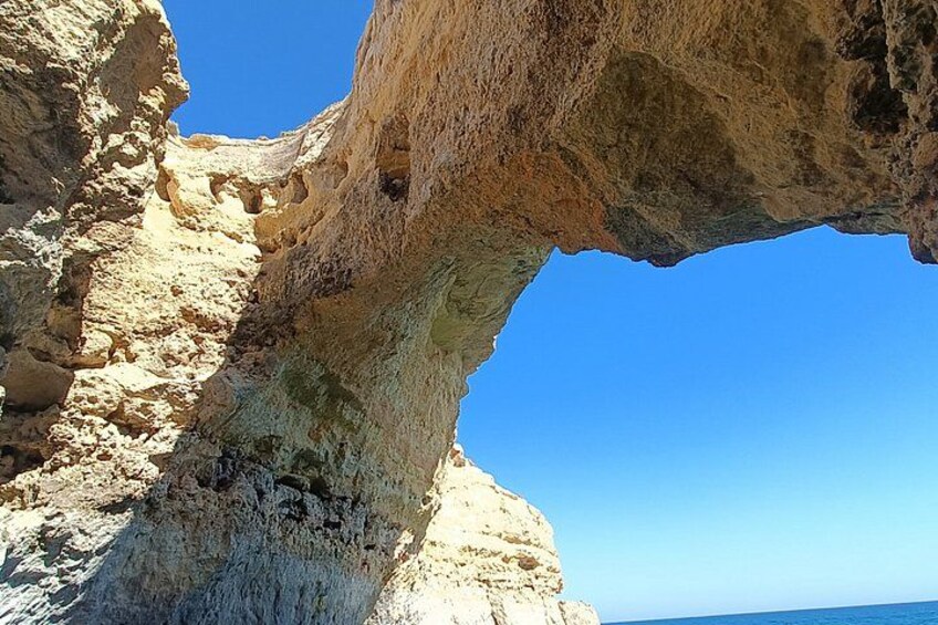 A large rock formation with a natural arch. 2