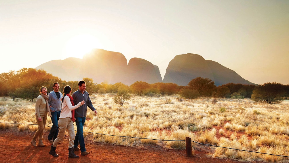 Two couples walking on a dirt path in the valley of the winds