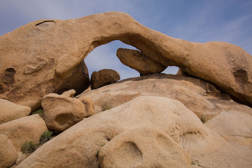 A natural rock formation with an arch. 1