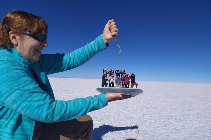 A person holding a plate with a group of people in the background. 5
