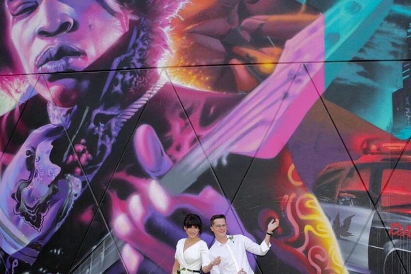 A mural with abstract and colorful designs, including a figure with a halo and a car. 4