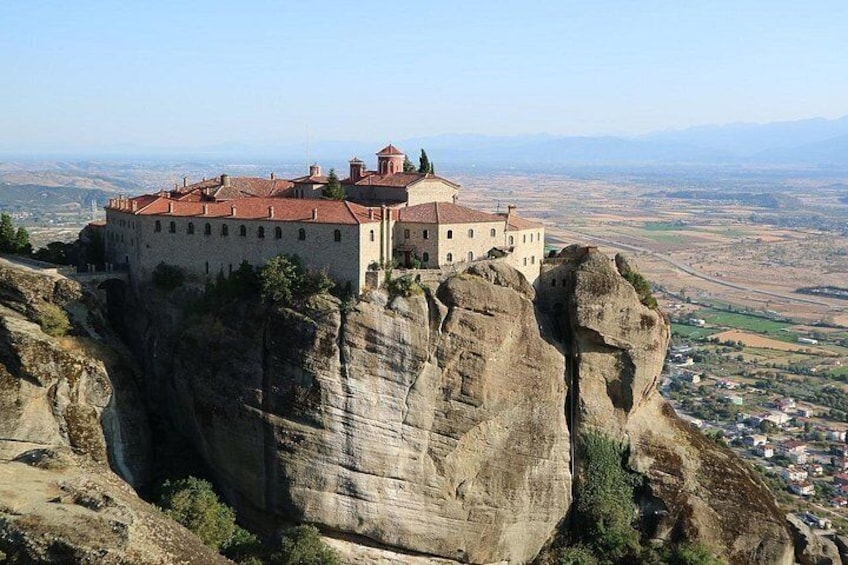 A castle on a rocky cliff overlooking a valley. 2