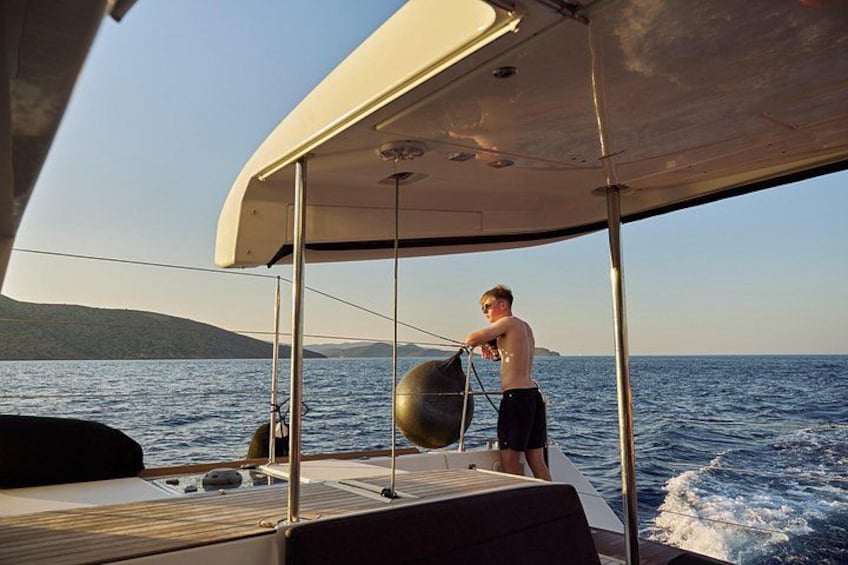 Una persona a bordo di una barca a vela, con vista libera sul mare e sulla costa in lontananza. 4