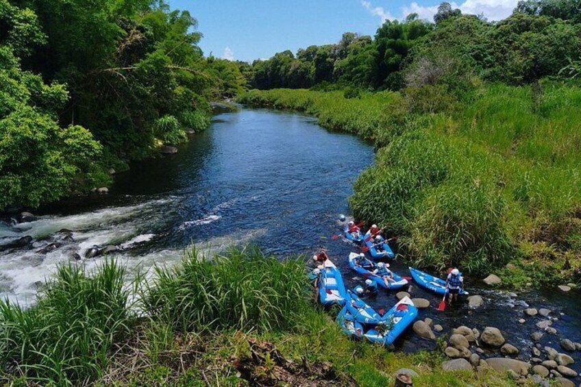 A river with kayaks and people. 2