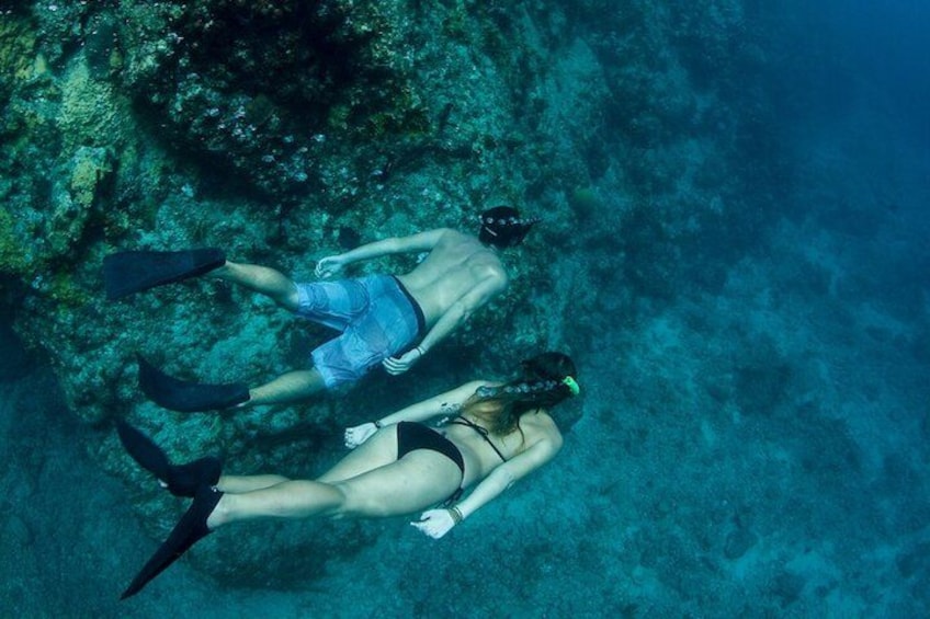 Two people snorkeling underwater. 2