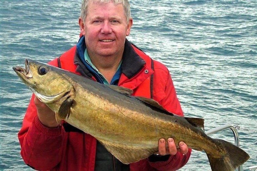 A person holding a large fish. 5