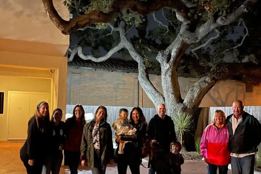 Un gruppo di persone in piedi di fronte a un grande albero artificiale. 1