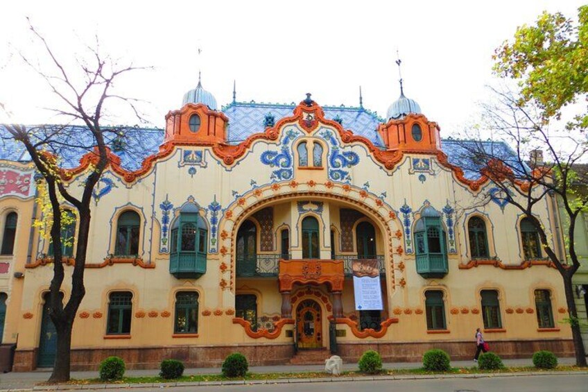 A colorful building with ornate architecture, featuring multiple domes and intricate designs. 1