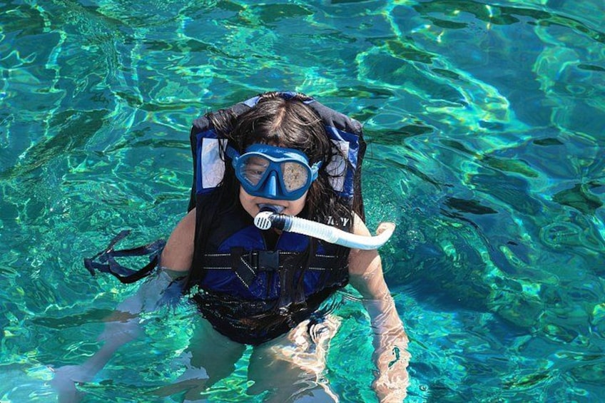 A person snorkeling in clear blue water. 5