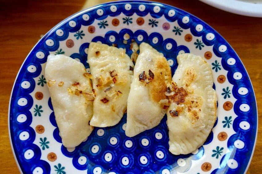 A plate of dumplings with a decorative blue and white pattern. 2