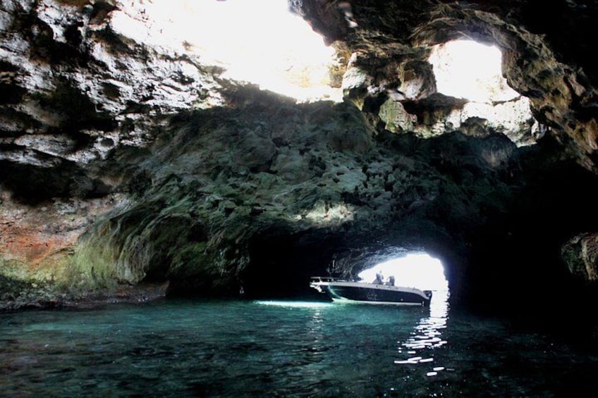 A boat in a cave with water at the bottom. 5