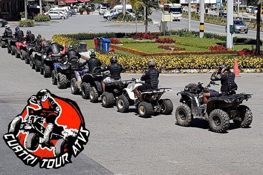 A line of quad bikes on a road with a logo of a rider on a bike. 3