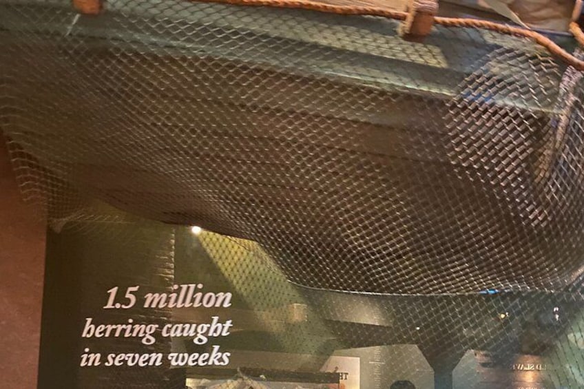 A fishing net with a text overlay stating '1.5 million bering caught in seven weeks.' 2