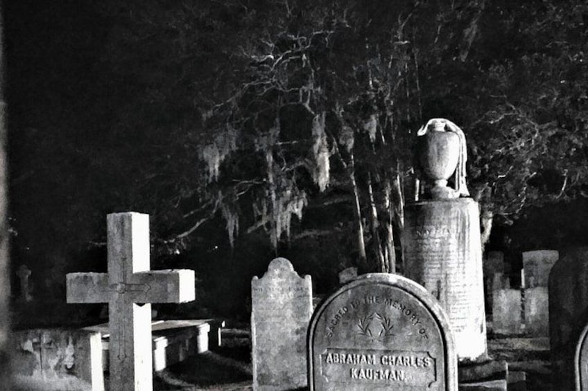 A cemetery with tombstones and crosses, including one marked 'Abraham Charles Kaufman.' 2