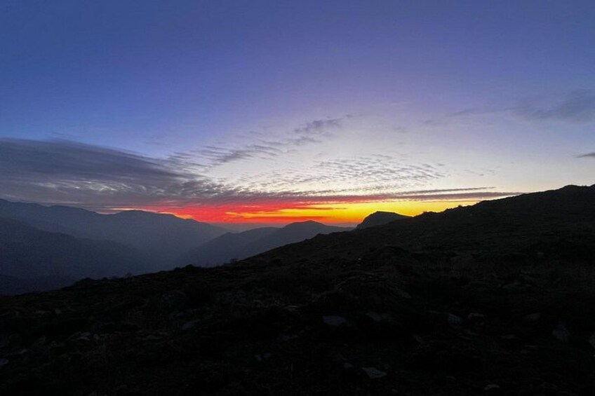 A mountainous landscape at sunset with a clear sky. 4